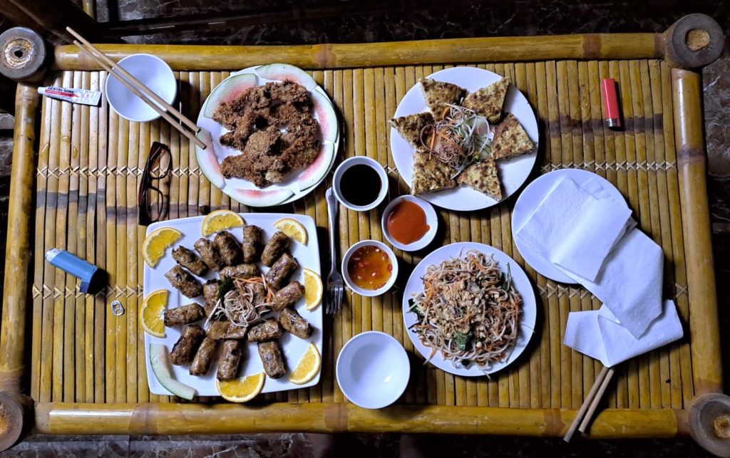 A bountiful spread of traditional Vietnamese dishes laid out at a local homestay.